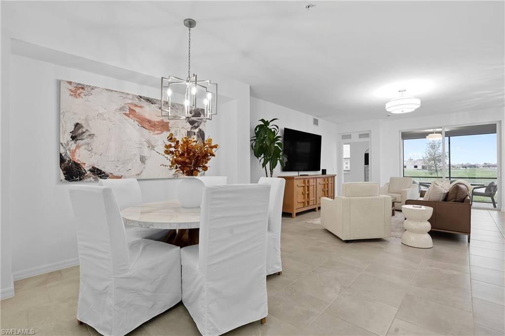 5667 Melbourne Court, Unit 7812 Ave Maria, FL 34142 - Photo 17 of 49 a living room with fireplace furniture and a chandelier