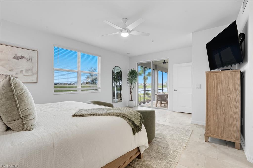 5667 Melbourne Court, Unit 7812 Ave Maria, FL 34142 - Photo 19 of 49 a spacious bedroom with a bed and a flat screen tv