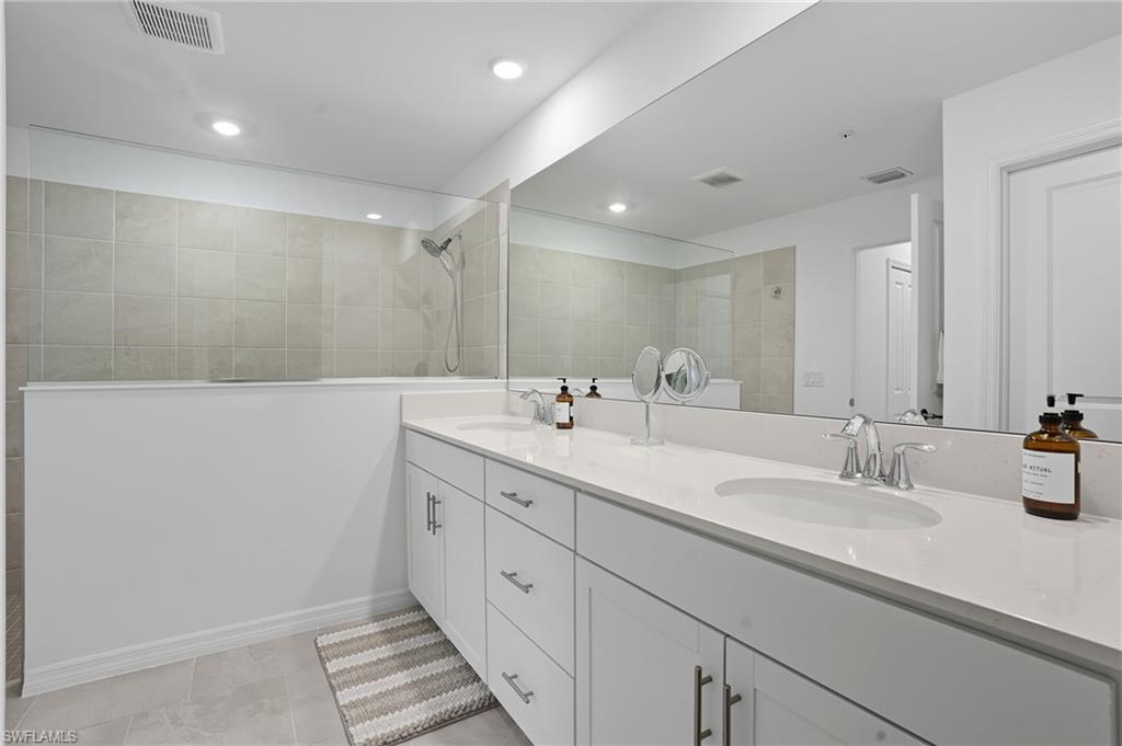 5667 Melbourne Court, Unit 7812 Ave Maria, FL 34142 - Photo 22 of 49 a bathroom with double sink and a mirror