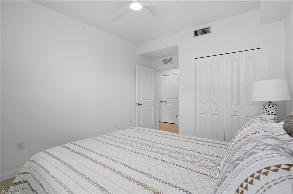 5667 Melbourne Court, Unit 7812 Ave Maria, FL 34142 - Photo 25 of 49 a bedroom with a bed and a lamp