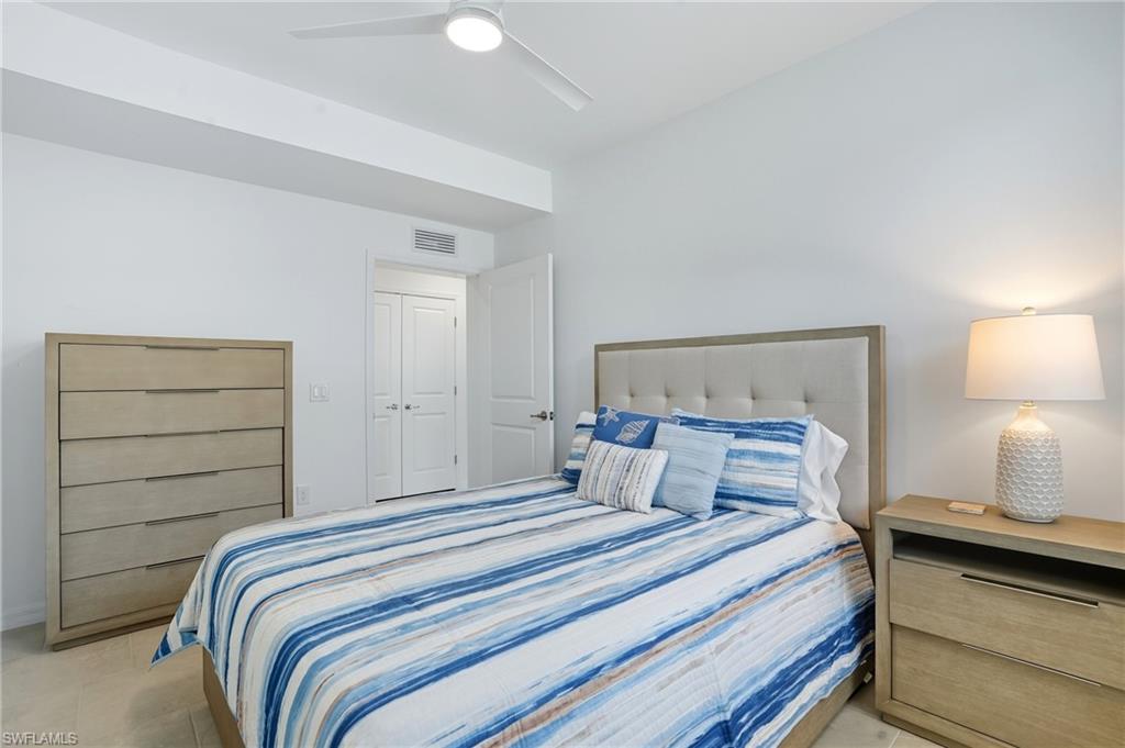 5667 Melbourne Court, Unit 7812 Ave Maria, FL 34142 - Photo 27 of 49 a bedroom with a bed and a lamp