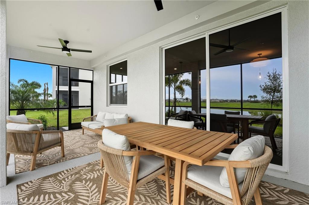 5667 Melbourne Court, Unit 7812 Ave Maria, FL 34142 - Photo 31 of 49 a view of a dining room with furniture wooden floor and chandelier