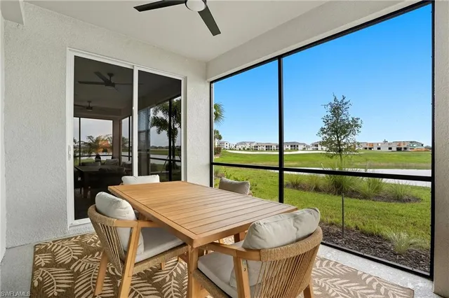 a dining room with furniture and a floor to ceiling window