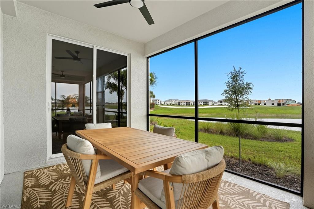 5667 Melbourne Court, Unit 7812 Ave Maria, FL 34142 - Photo 35 of 49 a dining room with furniture and a floor to ceiling window