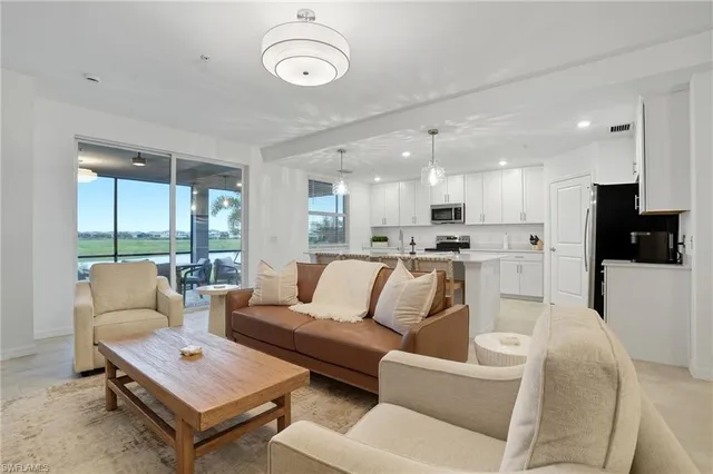 a view of a living room kitchen and a large window