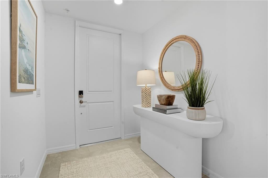 5667 Melbourne Court, Unit 7812 Ave Maria, FL 34142 - Photo 5 of 49 a bathroom with a sink a mirror and a potted plant