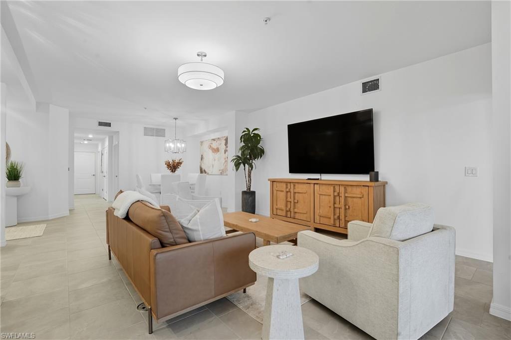 5667 Melbourne Court, Unit 7812 Ave Maria, FL 34142 - Photo 6 of 49 a living room with furniture and a flat screen tv