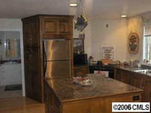 3907 Plyler Mill Road Monroe, NC 28112 - Photo 6 of 8 a kitchen with a sink and refrigerator