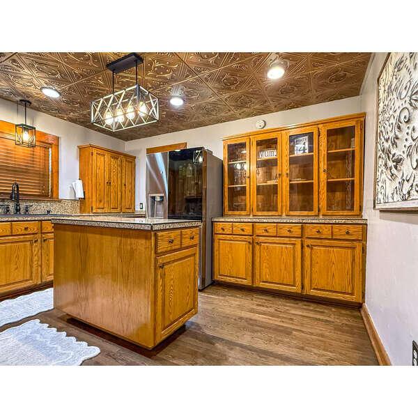 933 Elmore Street Borger, TX 79007 - Photo 16 of 53 a view of a living room and kitchen with furniture wooden floor and a kitchen view