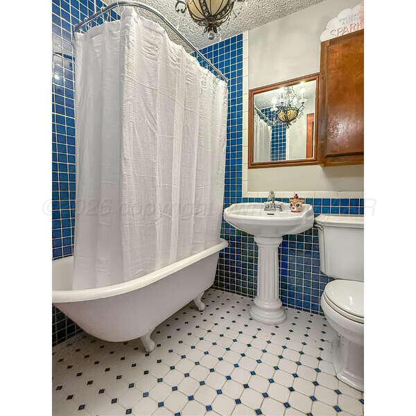 933 Elmore Street Borger, TX 79007 - Photo 27 of 53 a bathroom with a sink toilet and shower