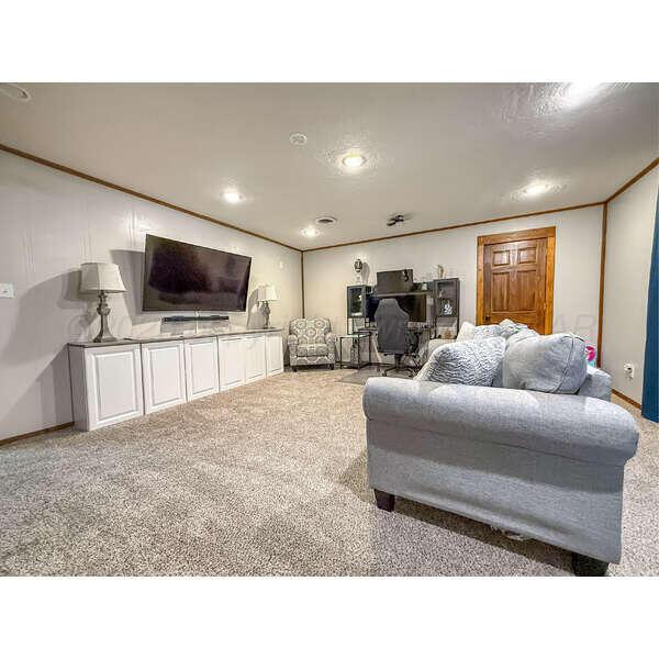 933 Elmore Street Borger, TX 79007 - Photo 29 of 53 a living room with furniture and a flat screen tv