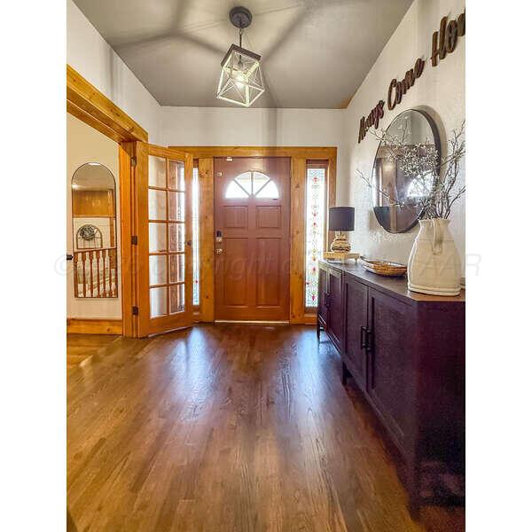 933 Elmore Street Borger, TX 79007 - Photo 8 of 53 a view of a room with wooden floor and windows