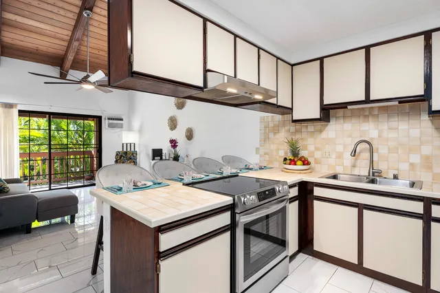 a kitchen with stainless steel appliances granite countertop a sink refrigerator and cabinets