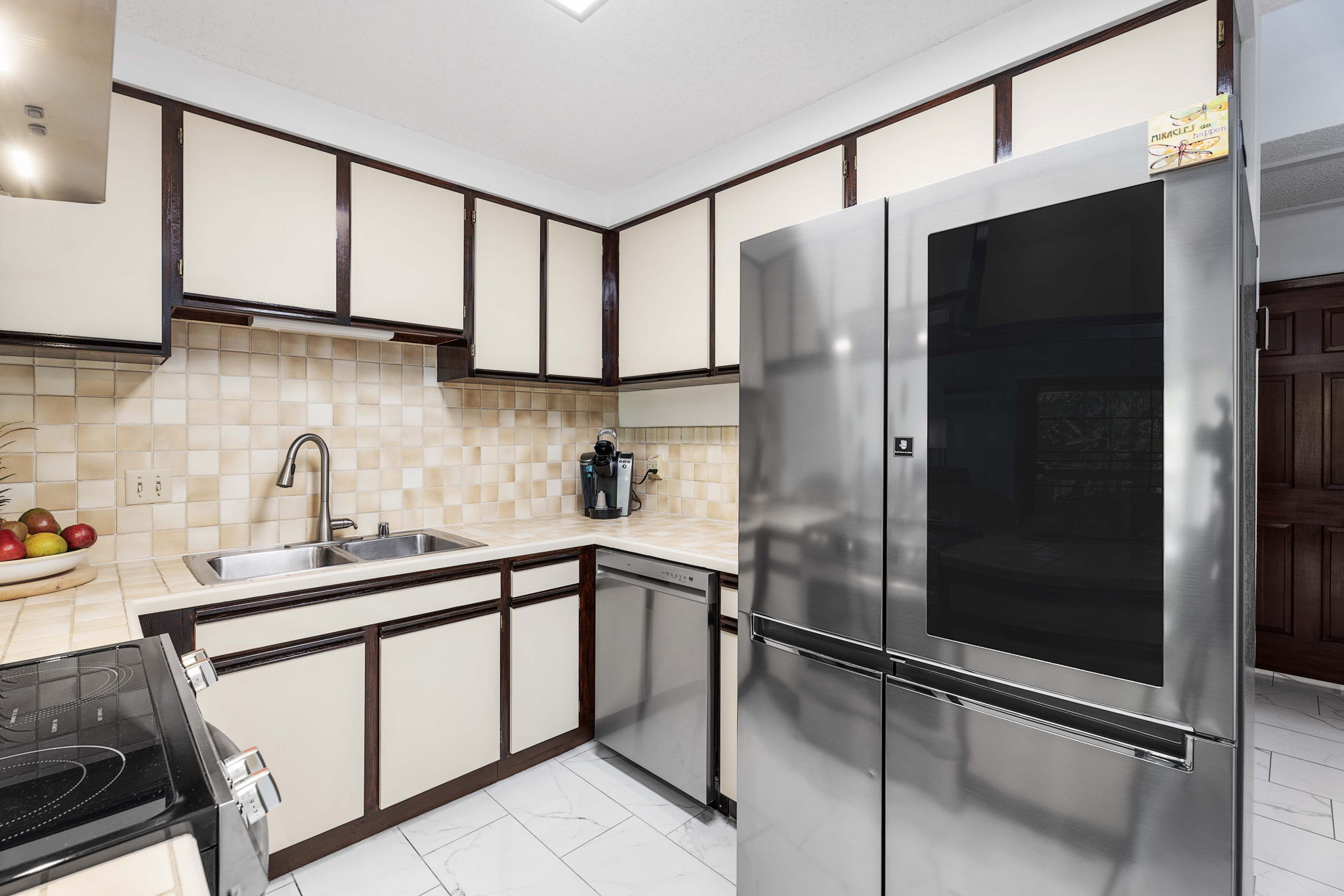 75-123 Lunapule Road, Unit 107 Kailua-Kona, HI 96740 - Photo 12 of 17 a kitchen with stainless steel appliances granite countertop a sink refrigerator and cabinets