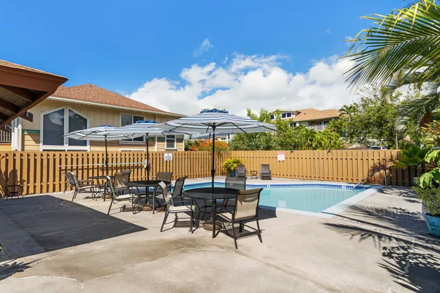 a view of a porch with a table and chairs
