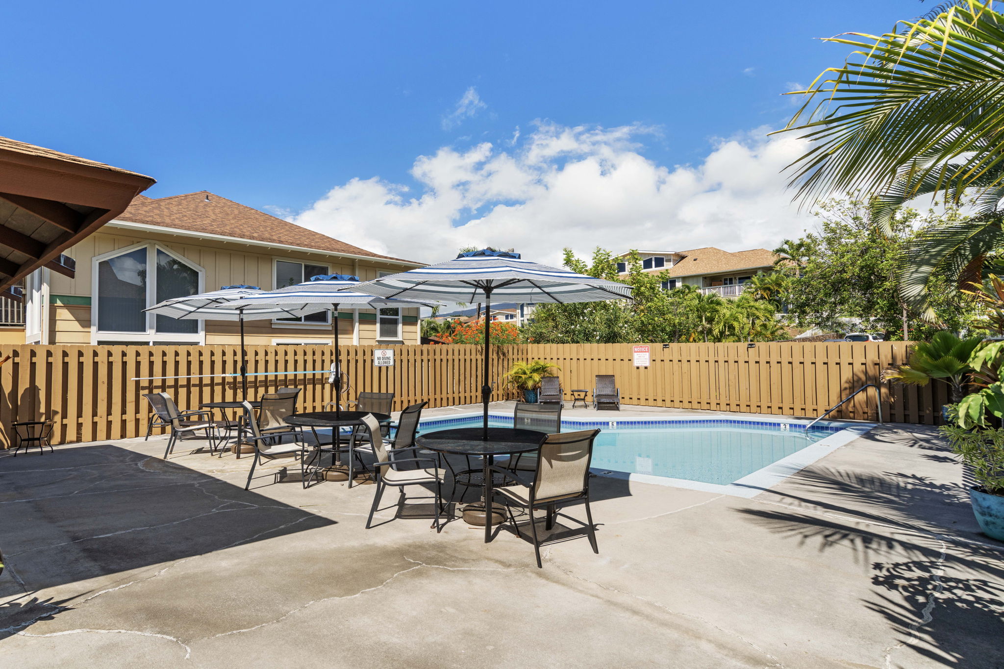 75-123 Lunapule Road, Unit 107 Kailua-Kona, HI 96740 - Photo 15 of 17 a view of a patio with a table chairs and a fire pit