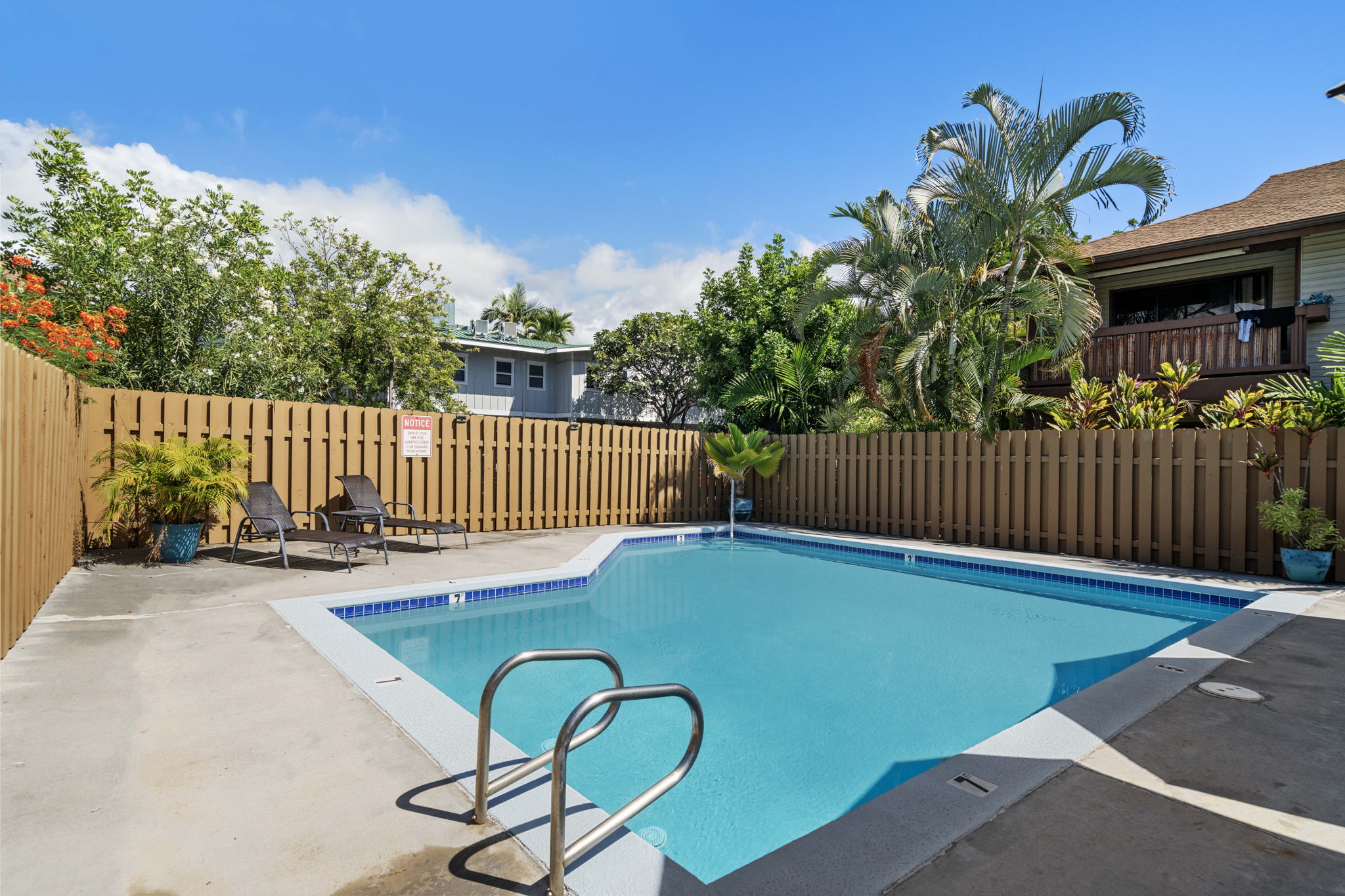 75-123 Lunapule Road, Unit 107 Kailua-Kona, HI 96740 - Photo 16 of 17 a view of a porch with a table and chairs