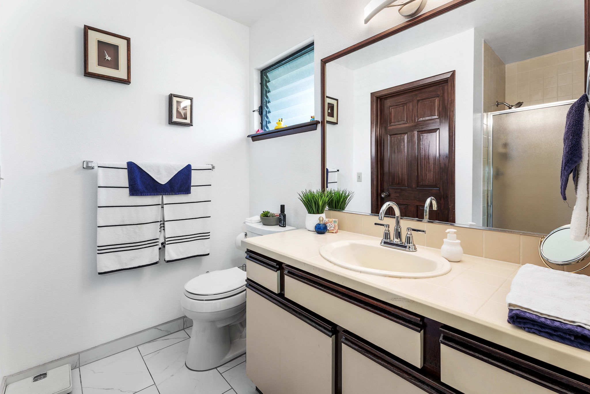 75-123 Lunapule Road, Unit 107 Kailua-Kona, HI 96740 - Photo 8 of 17 a bathroom with a sink a toilet and shower