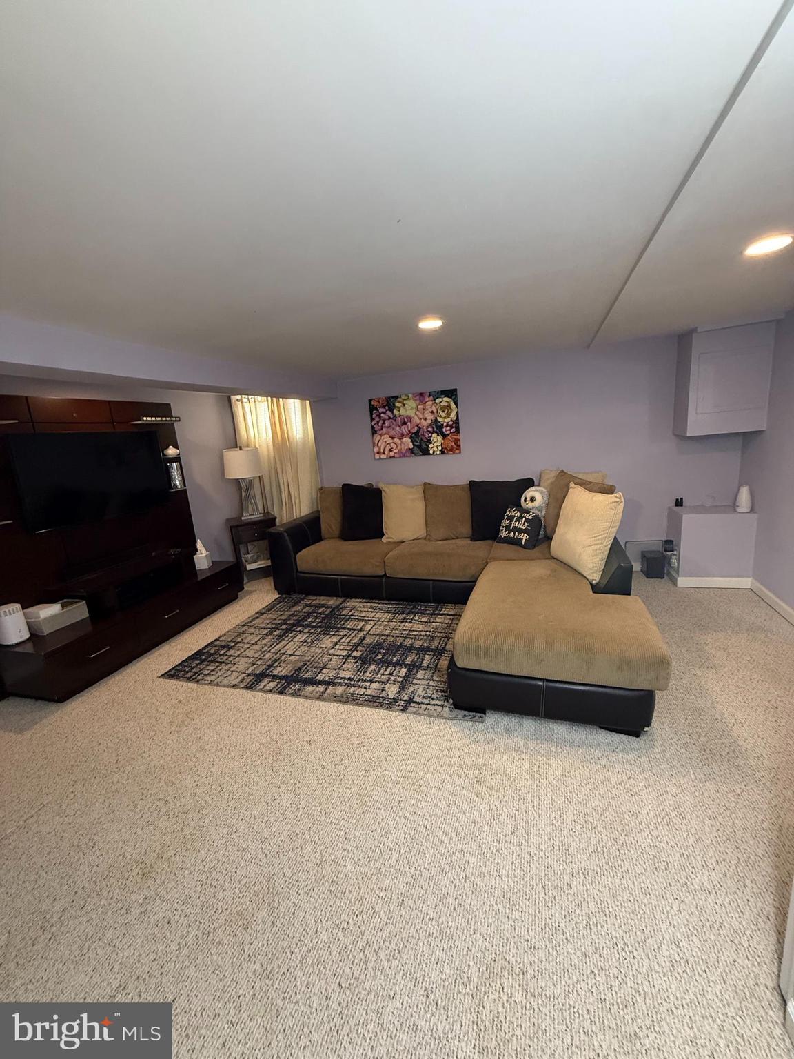 2235 Hawthorne Road Baltimore, MD 21220 - Photo 23 of 35 a bedroom with furniture and a flat screen tv