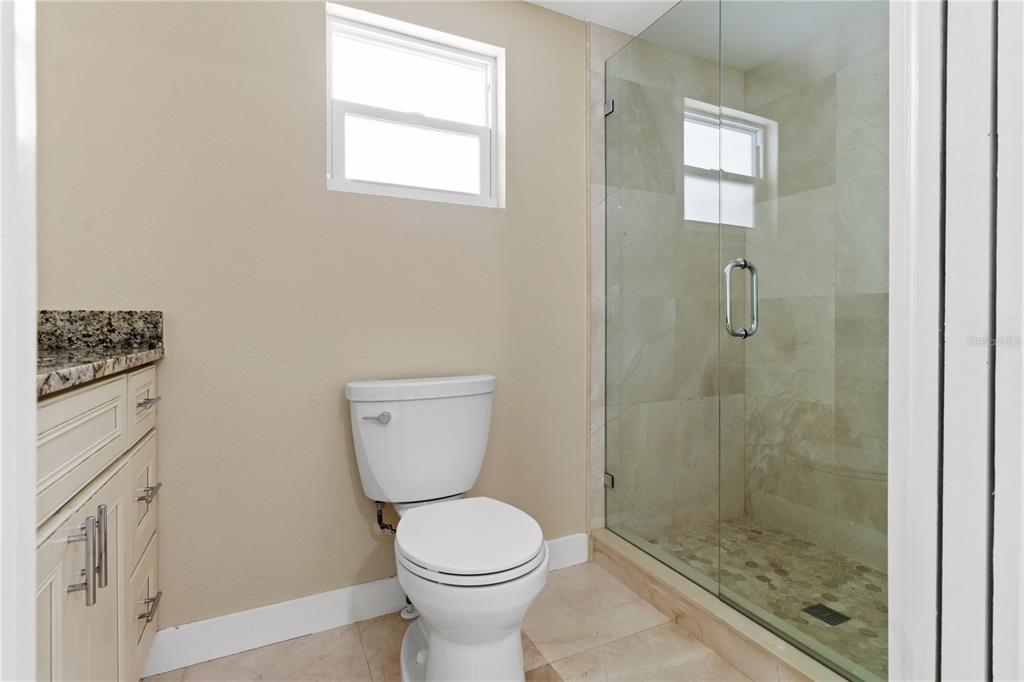 609 North Osceola Avenue Clearwater, FL 33755 - Photo 16 of 47 a bathroom with a toilet a sink a shower and mirror