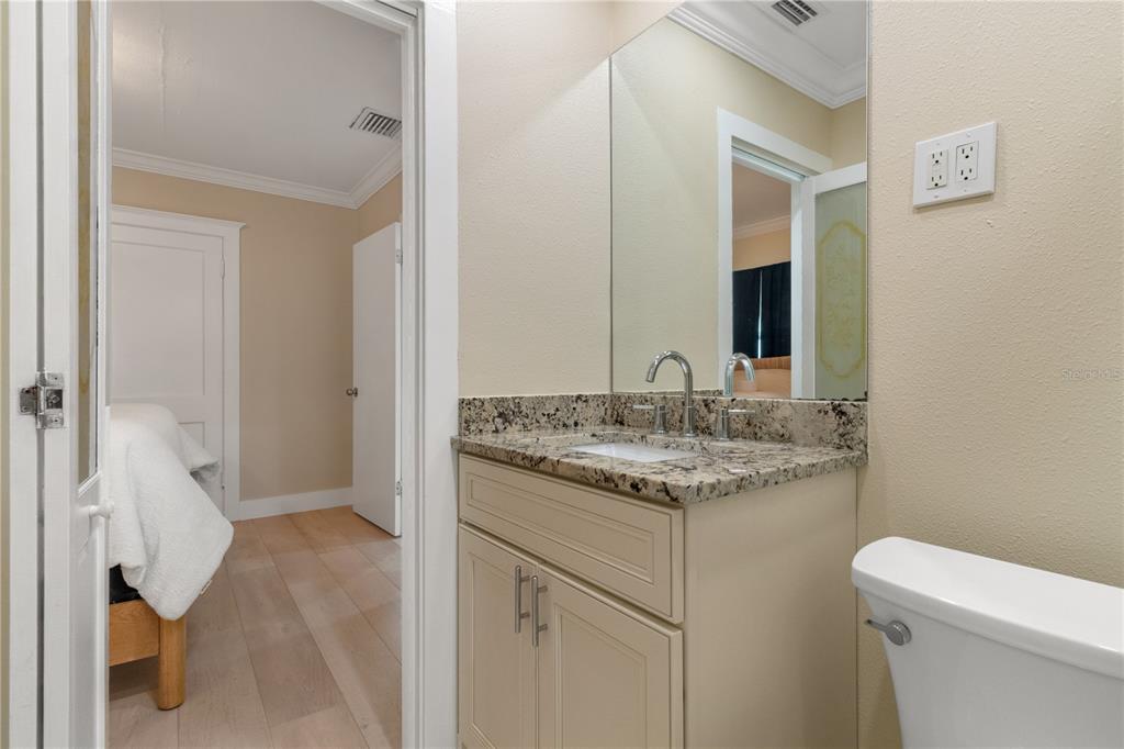 609 North Osceola Avenue Clearwater, FL 33755 - Photo 22 of 47 a bathroom with a granite countertop sink and a toilet