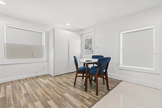 a dining room with furniture and wooden floor