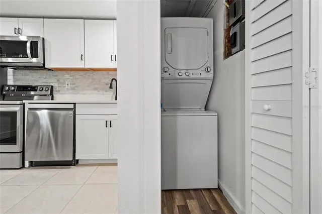 a utility room with cabinets washer and dryer