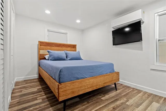 a bedroom with a bed and a flat screen tv