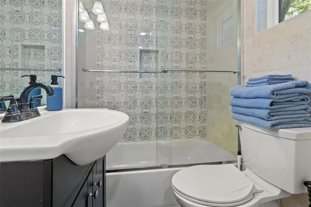 a bathroom with a sink toilet and shower