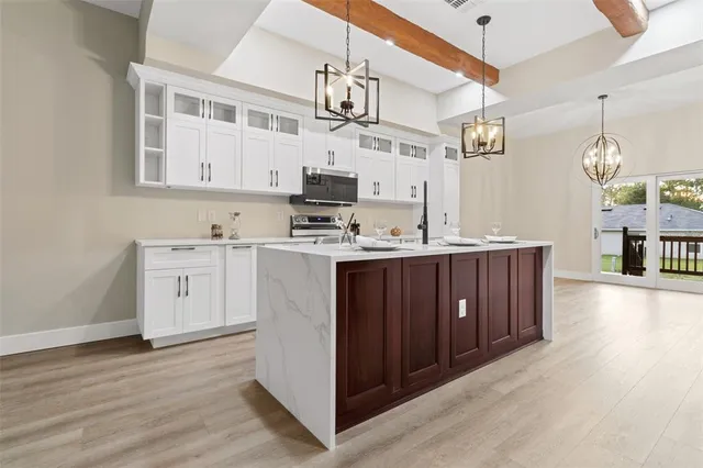 a kitchen with a sink cabinets and wooden floor
