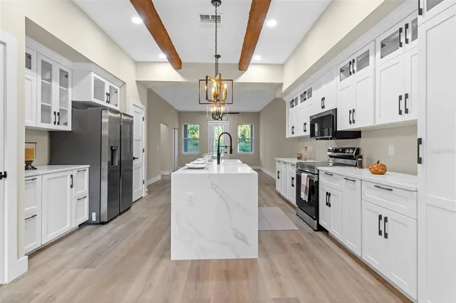 a kitchen with stainless steel appliances a refrigerator sink and cabinets