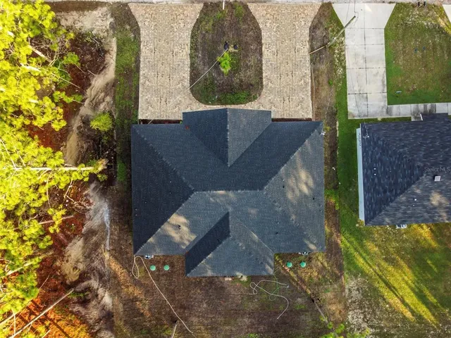 an aerial view of a house with outdoor space