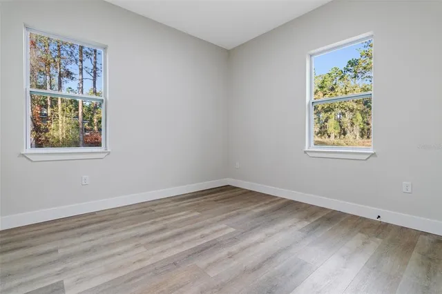 a view of room with window and wooden floor