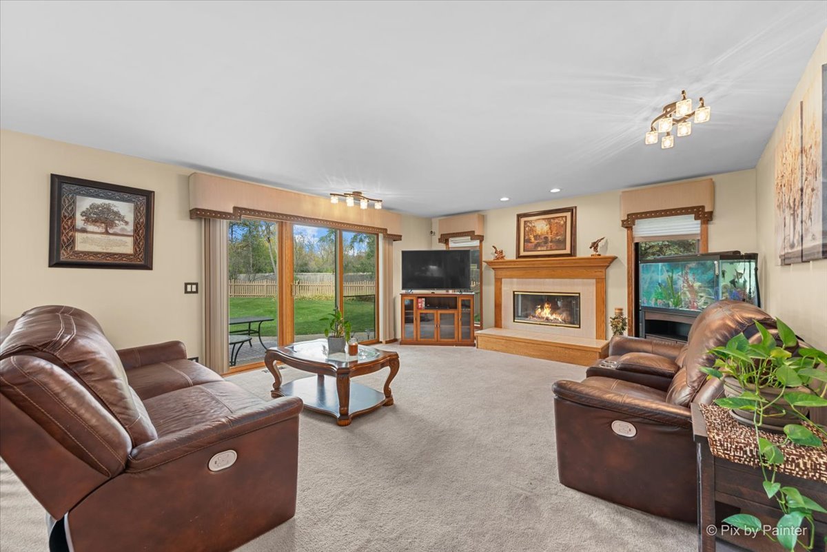 7203 Edgewood Court Spring Grove, IL 60081 - Photo 12 of 46 a living room with furniture and a fireplace