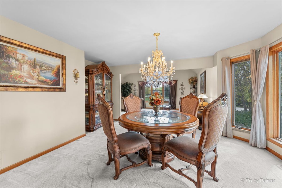 7203 Edgewood Court Spring Grove, IL 60081 - Photo 13 of 46 a dining room with furniture a chandelier and window
