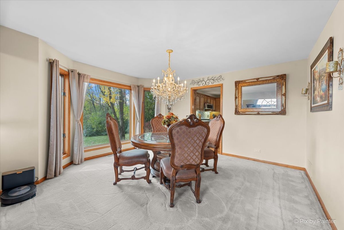 7203 Edgewood Court Spring Grove, IL 60081 - Photo 14 of 46 a dining room with furniture a chandelier and a window