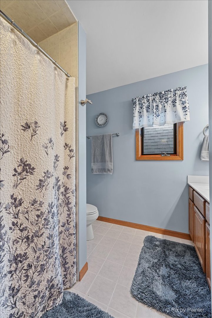 7203 Edgewood Court Spring Grove, IL 60081 - Photo 21 of 46 a bathroom with a toilet and shower