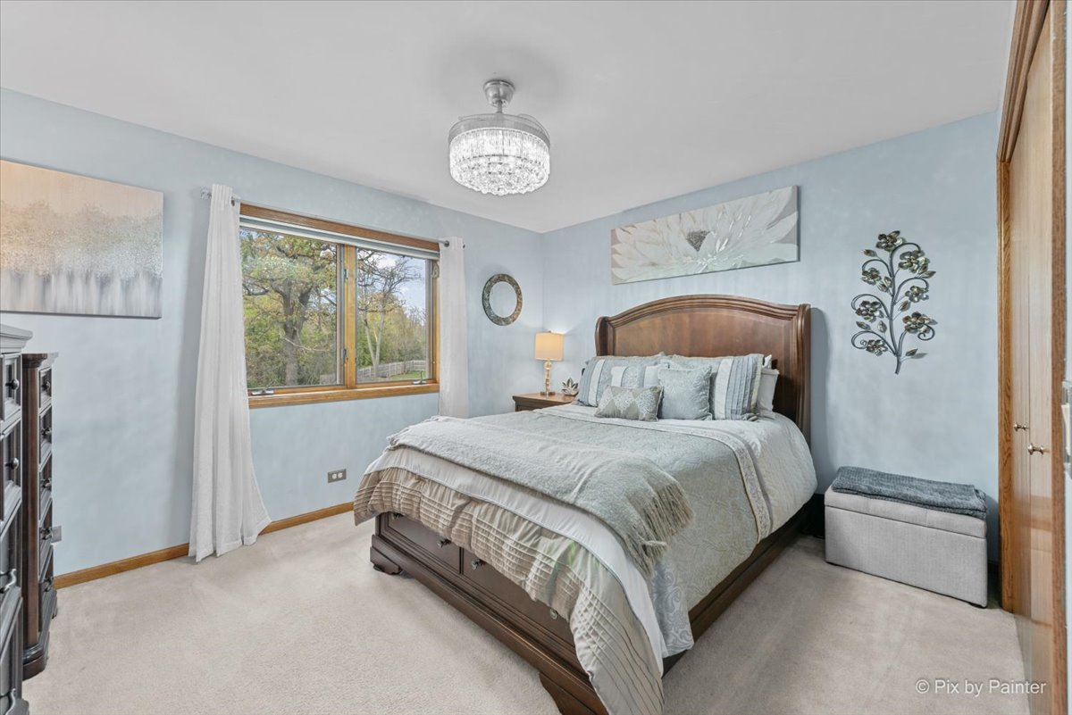 7203 Edgewood Court Spring Grove, IL 60081 - Photo 24 of 46 a bedroom with a bed and a window