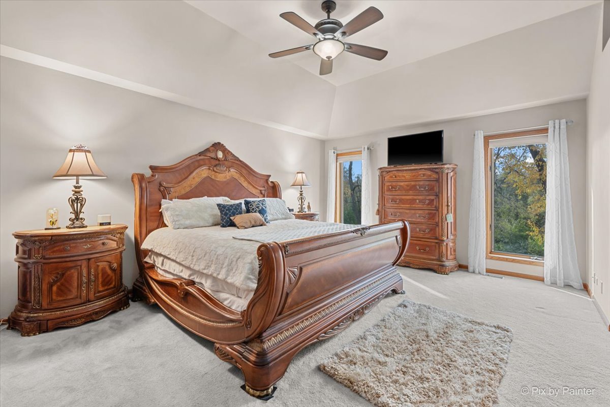 7203 Edgewood Court Spring Grove, IL 60081 - Photo 27 of 46 a bedroom with a bed and a chandelier