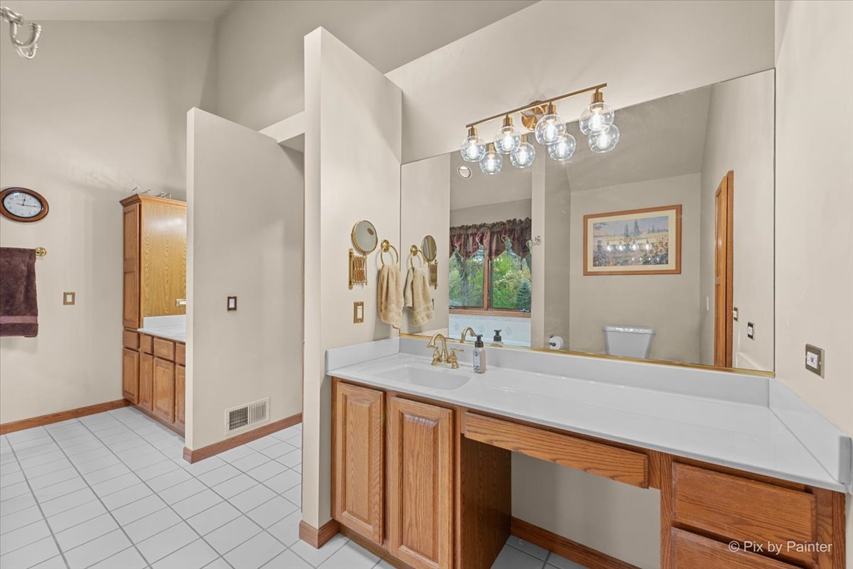 7203 Edgewood Court Spring Grove, IL 60081 - Photo 30 of 46 a bathroom with a double vanity sink mirror and shower