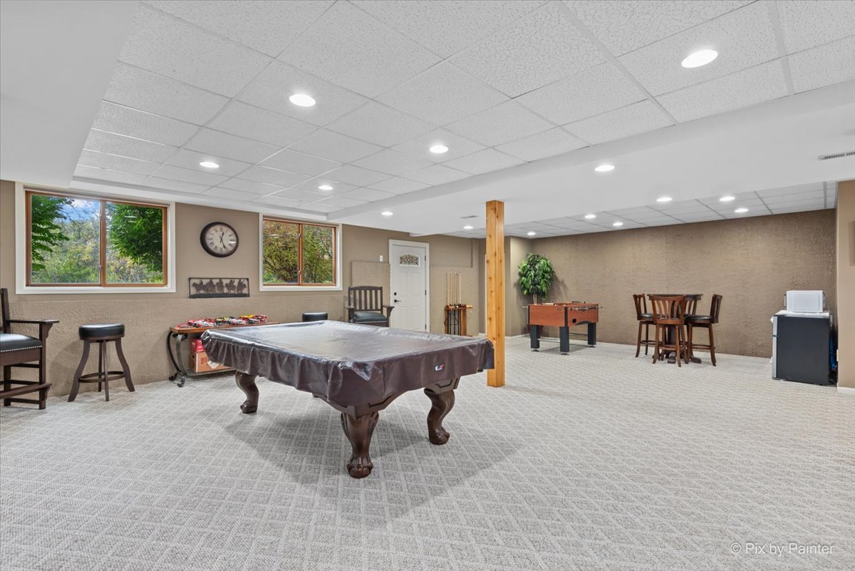 7203 Edgewood Court Spring Grove, IL 60081 - Photo 33 of 46 a living room with furniture a table and large windows