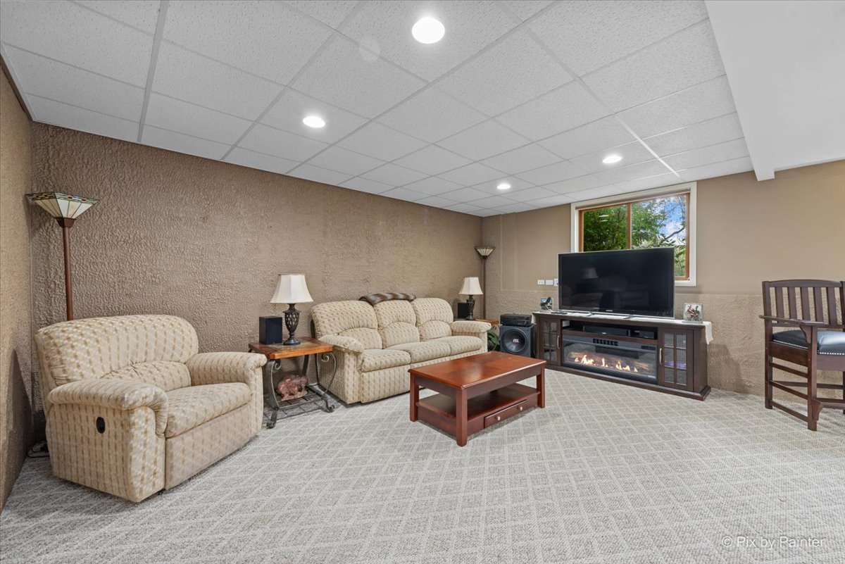7203 Edgewood Court Spring Grove, IL 60081 - Photo 34 of 46 a living room with furniture and a flat screen tv