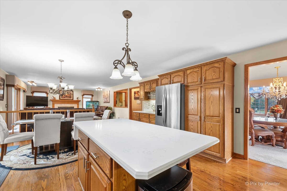 7203 Edgewood Court Spring Grove, IL 60081 - Photo 8 of 46 a large kitchen with a table and chairs
