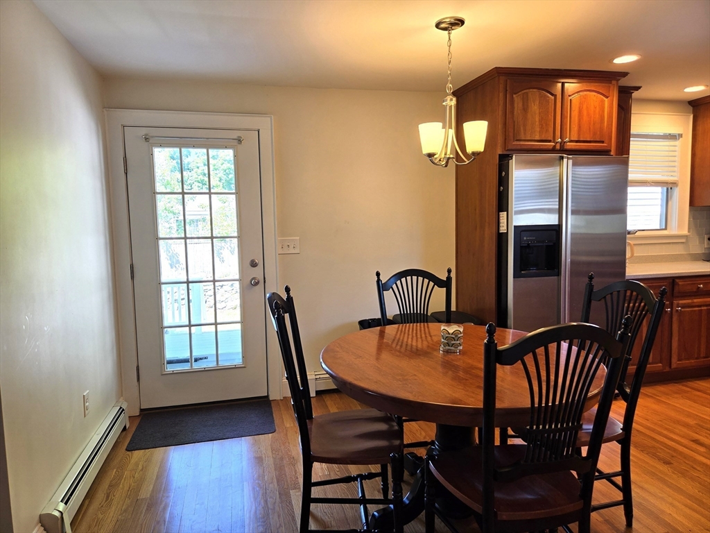 25 Waldeck Road Milton, MA 02186 - Photo 15 of 34 a view of a dining room with furniture window and wooden floor