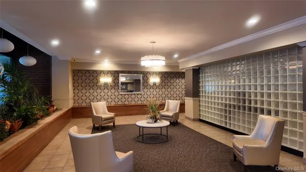 a lobby with furniture and potted plants