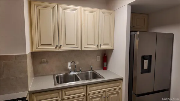 a kitchen with granite countertop a stove and a refrigerator