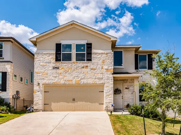 a front view of a house with yard