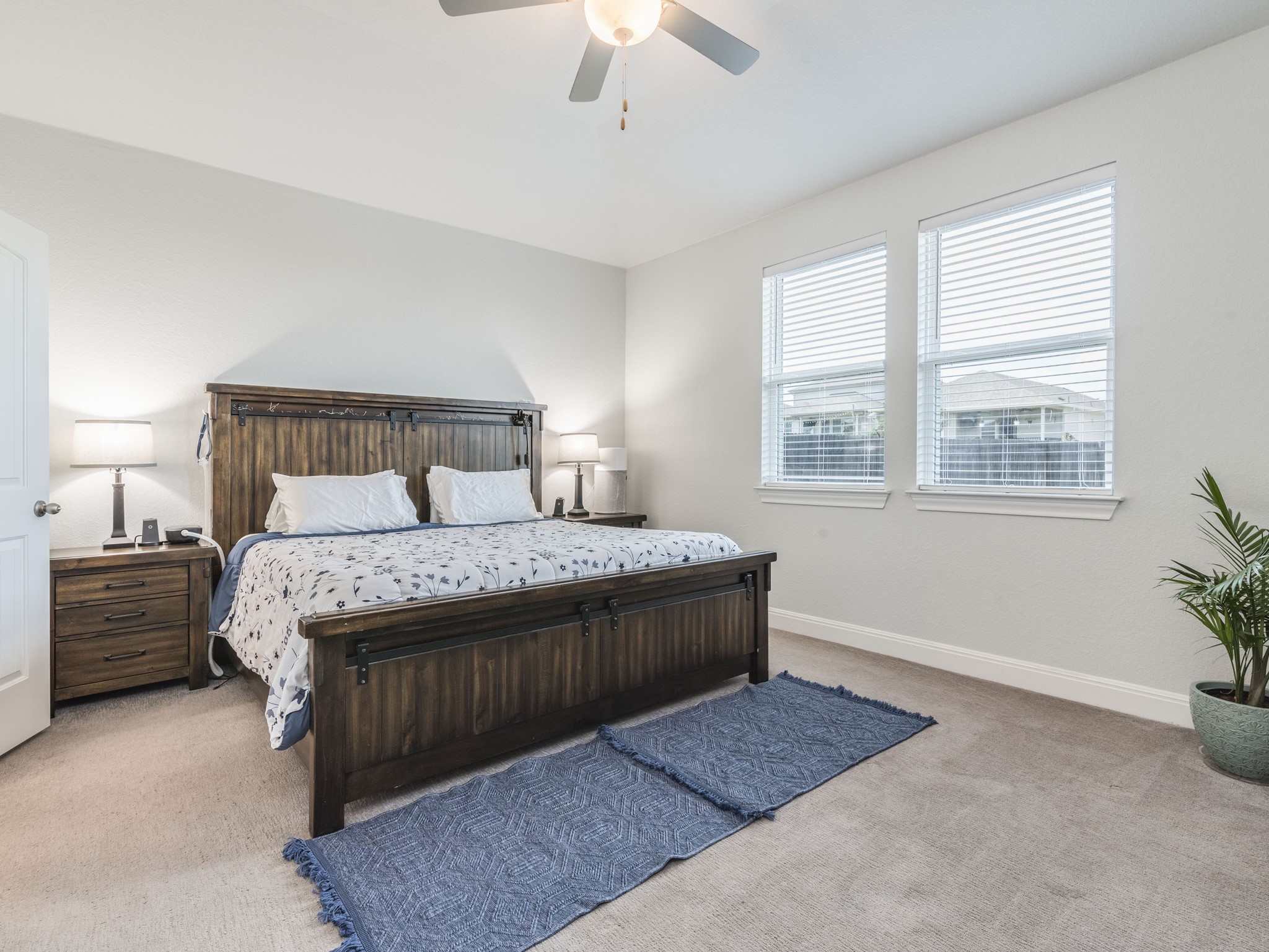 142 Mount Locke Road Dripping Springs, TX 78620 - Photo 11 of 31 a bed sitting in a bedroom next to a window