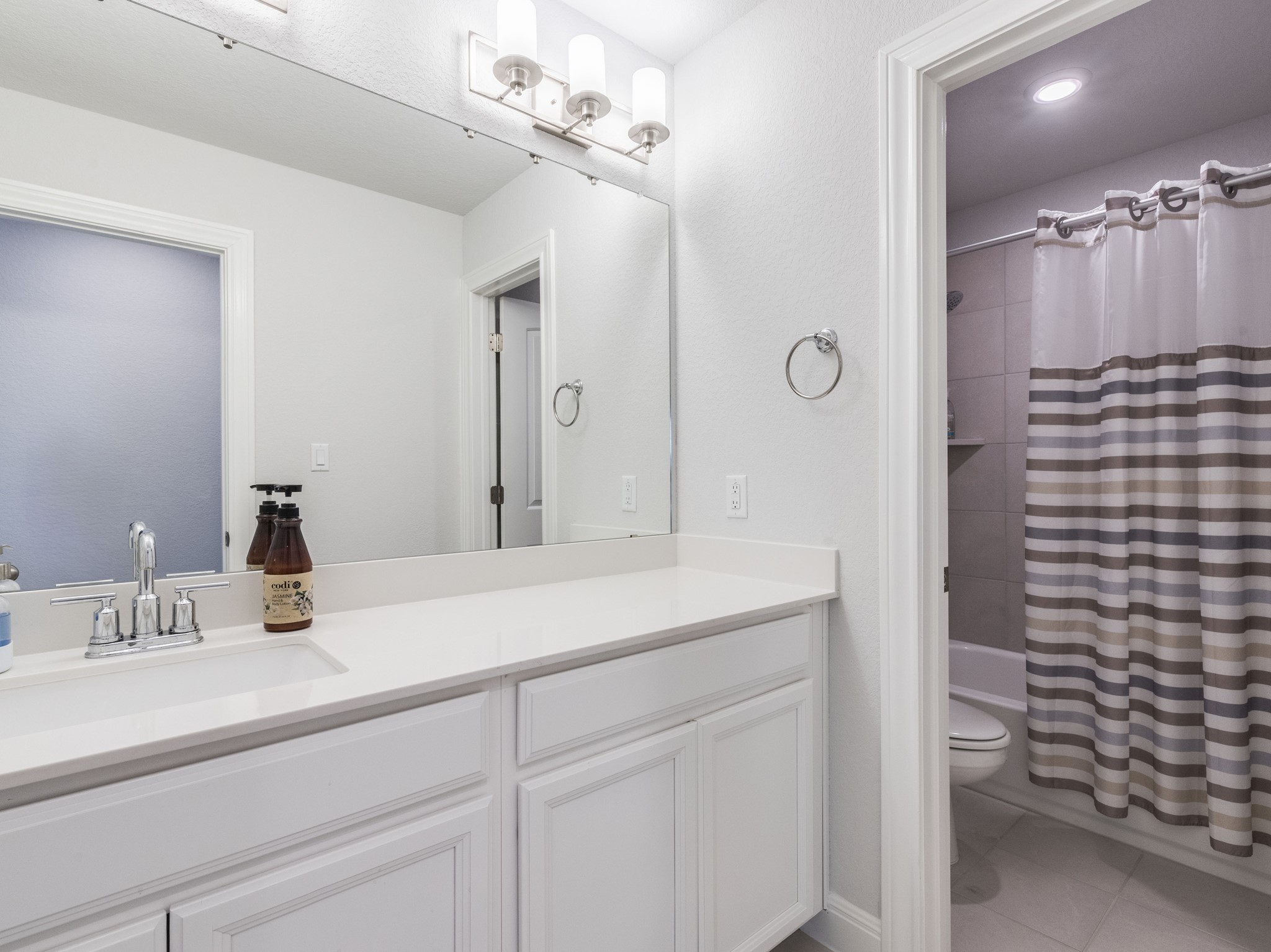 142 Mount Locke Road Dripping Springs, TX 78620 - Photo 25 of 31 a bathroom with a sink a vanity and shower