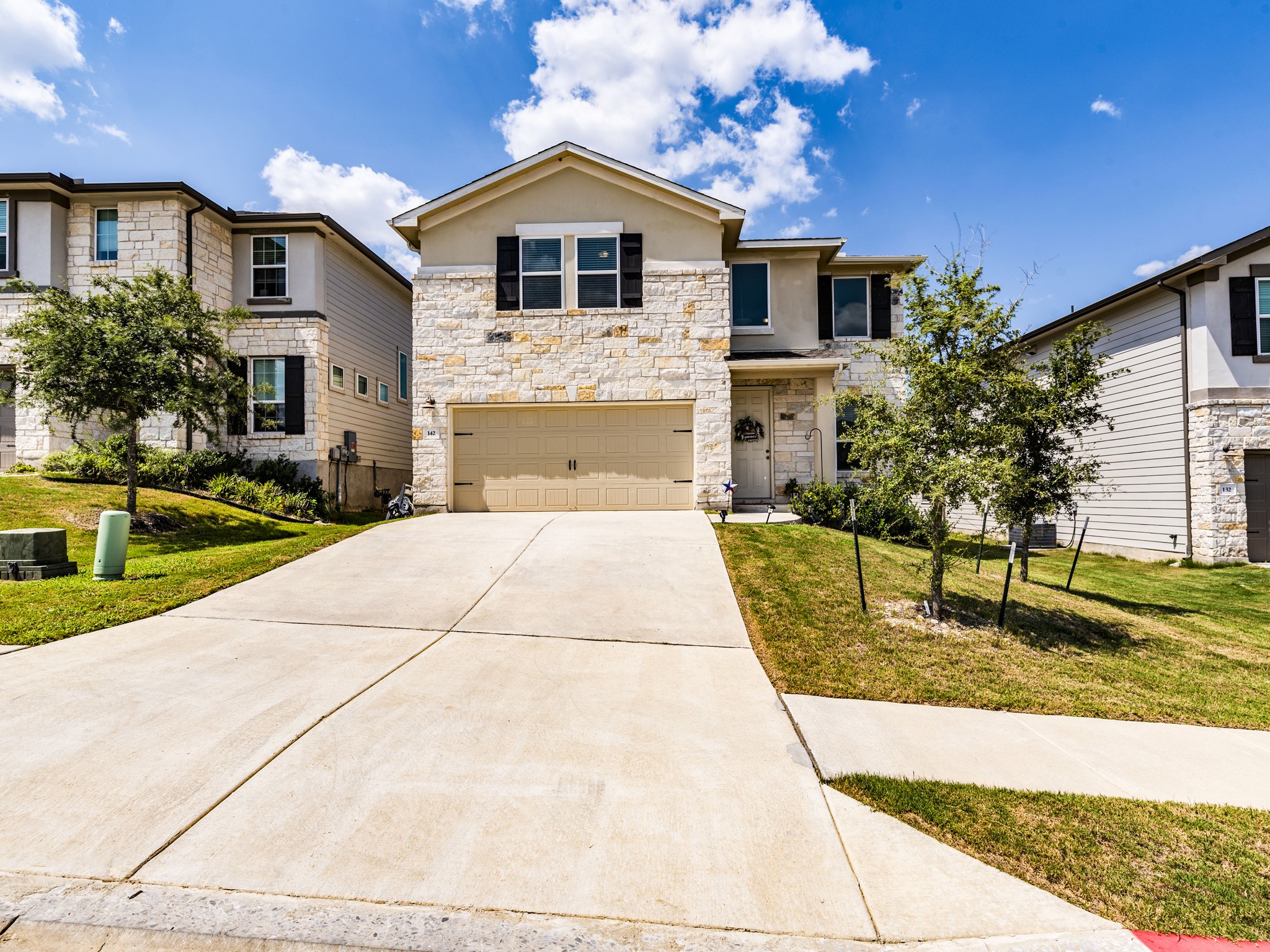 142 Mount Locke Road Dripping Springs, TX 78620 - Photo 3 of 31 a front view of a house with garden